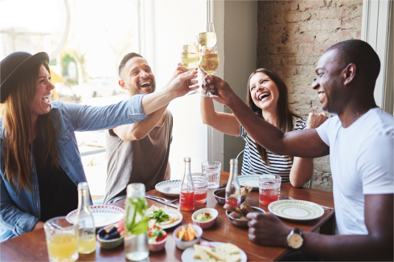 People are toasting for a successful restaurant fundraiser.