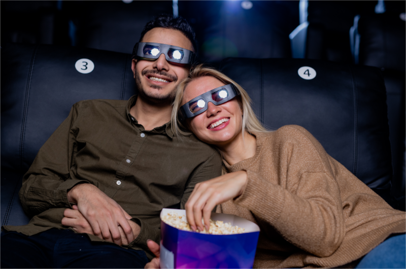 A couple are attending a romantic movie marathon fundraising event.