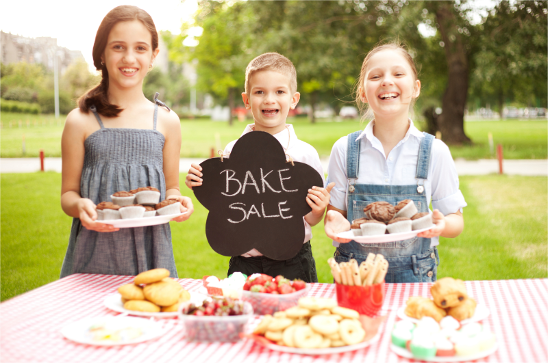 Kids engage in a bake sale fundraiser.