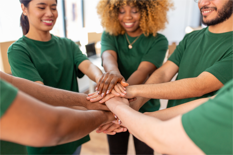 A team is cheering after making a nonprofit fundraising plan.