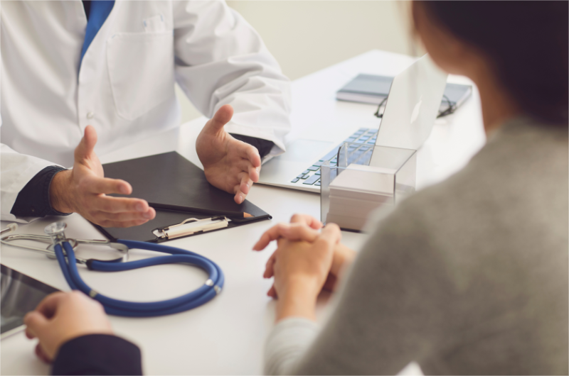 A doctor is talking with his patient about the medical expenses.