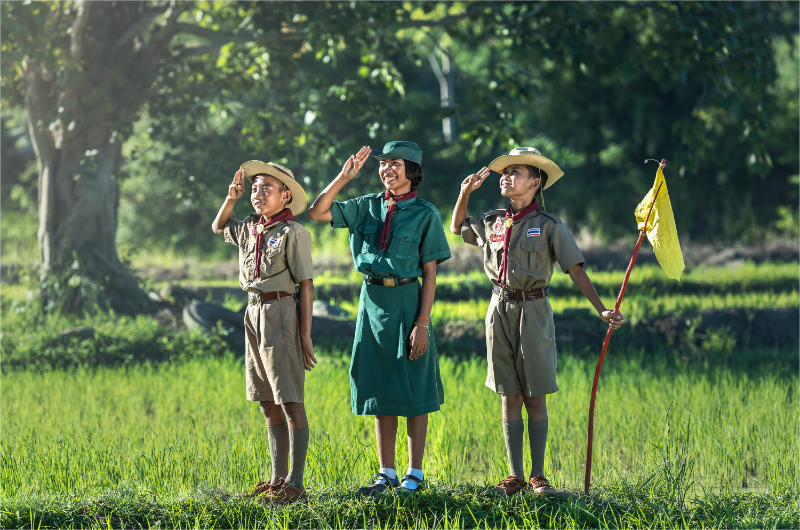 3 Eagle Scouts smile with honor hand gesture