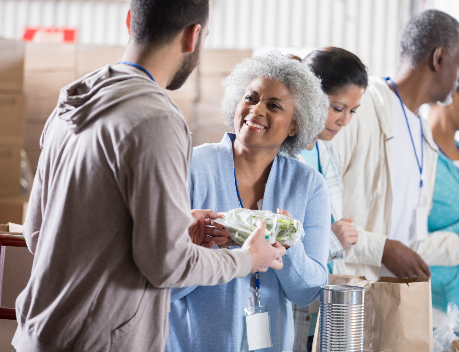 A nonprofit is distributing donations to the old person.